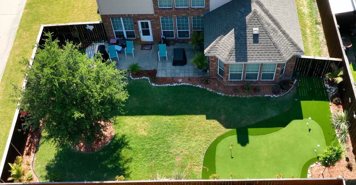 Beautiful backyard putting green with artificial grass